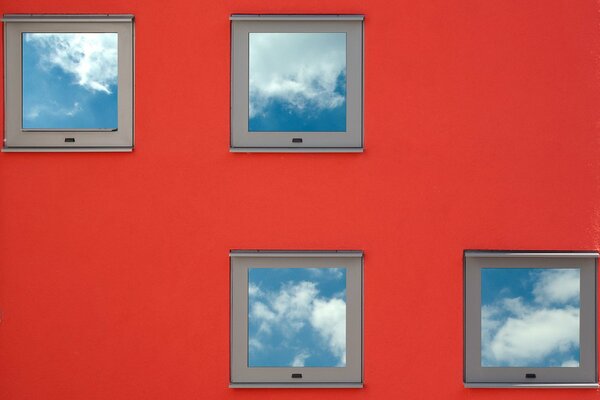 Small square windows on a red wall