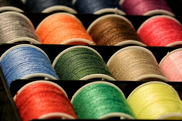 Multicolored threads on the pots are in a box