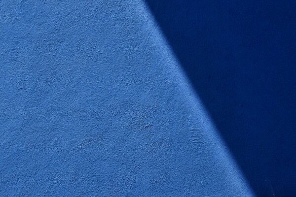 Blue wall with texture and shadow