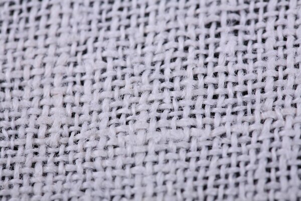 Interweaving of threads on white fabric