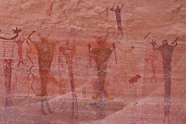 Rock art with people with their hands raised