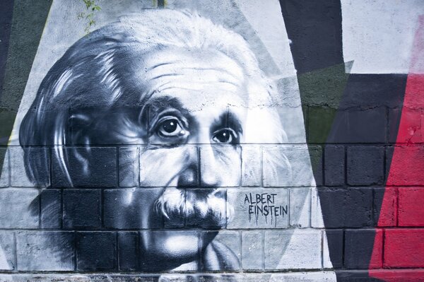 Street graffiti with Albert Einstein on the wall in black and white