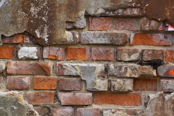 Broken bricks on the old wall