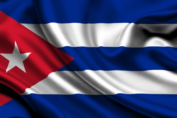 The flag of Cuba is a white star on a red triangle with white and blue stripes