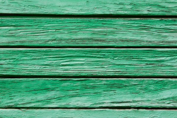 A wall of green wooden boards