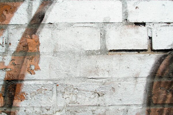 An image of a decorated old white brick wall