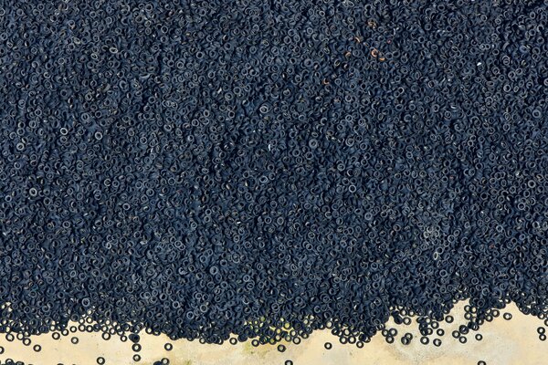 A large number of dark tires of rubber wheels