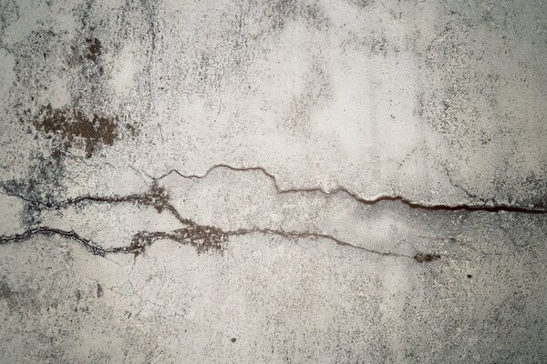 Cracks in time on a concrete wall