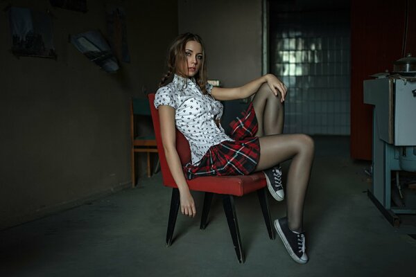 Ksenia in a blouse and skirt shows her legs