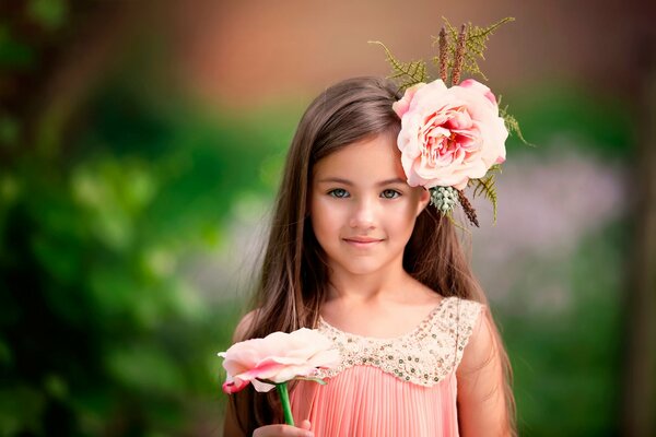 Beautiful girl with a pink flower in her hair