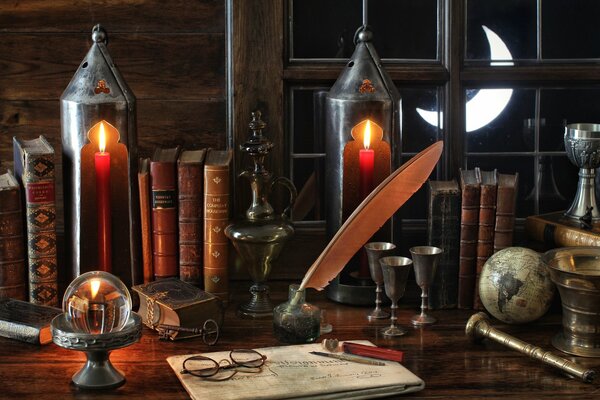 Still life with old books, crystal ball, candles and goose quill