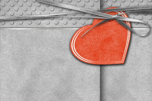 Gray postcard tied with a ribbon with a red heart