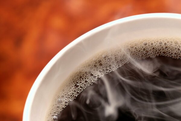 Cup with black coffee and bubbles