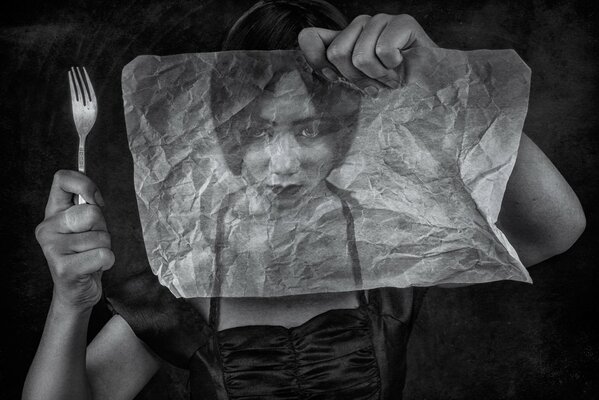 Image of a girl with a fork through a crumpled tracing paper