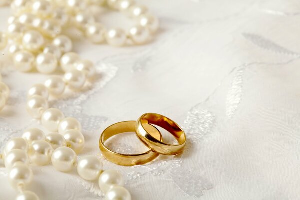 Wedding rings on a white tablecloth