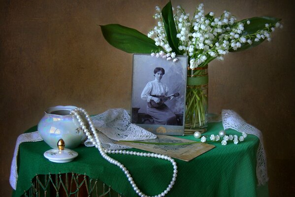 Retro photo on the table with lilies of the valley