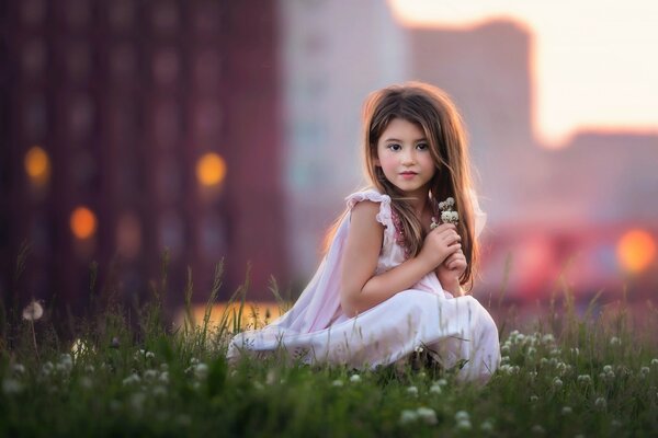 A girl in a flower meadow. The image of an angel