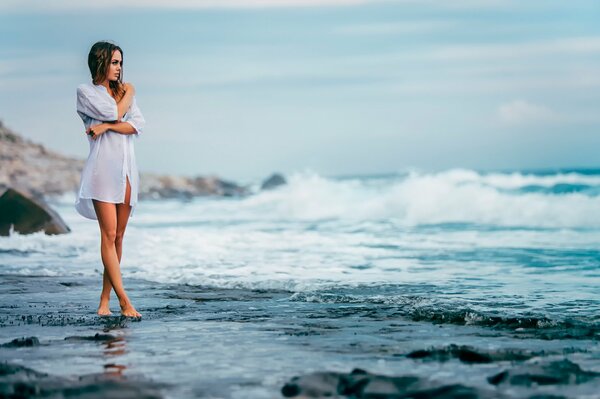 A girl in a shirt on the seashore