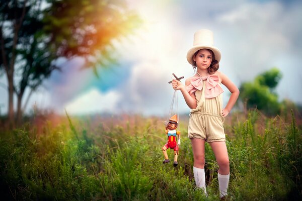 A girl in a hat with a pinocchio puppet