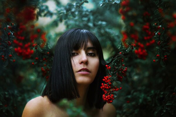 Black-haired girl on the background of nature