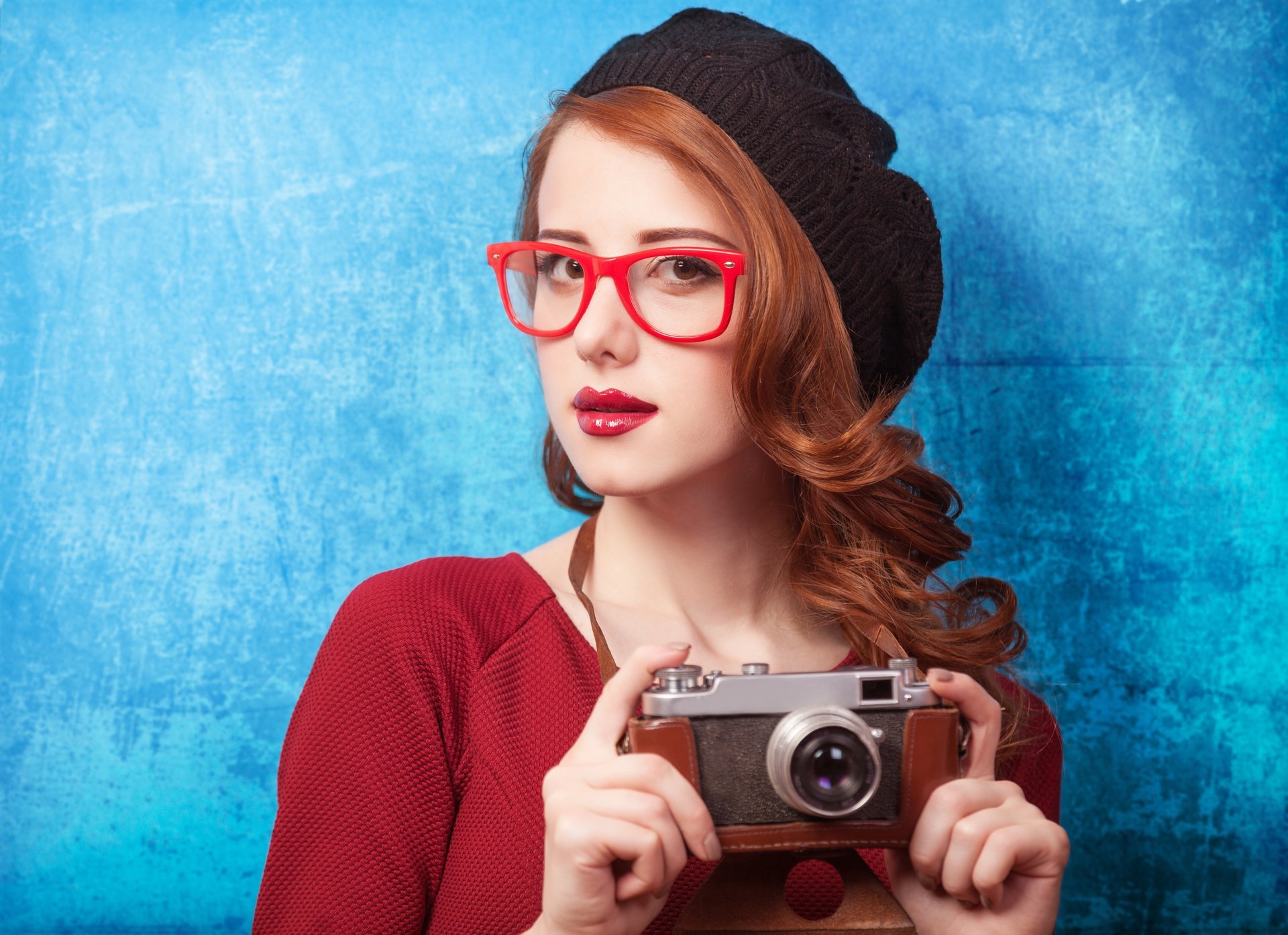 girl red hair sunglasses view a camera