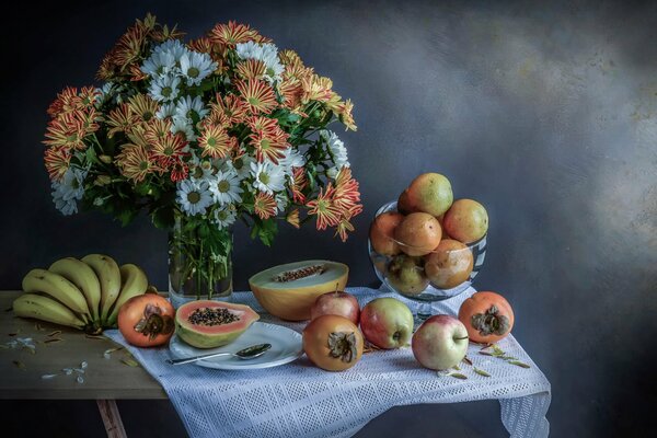 Still life with tropical flowers and fruits