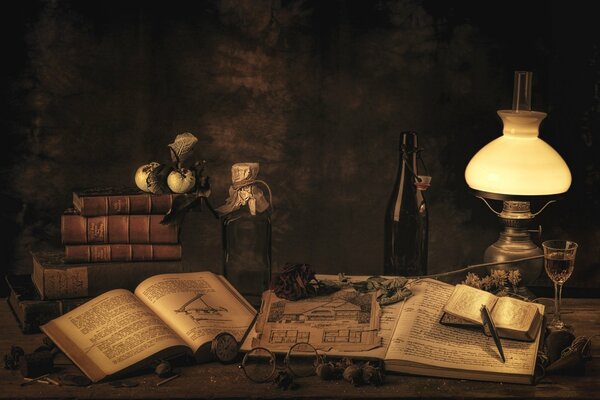 Still life of a desktop with books under a lamp