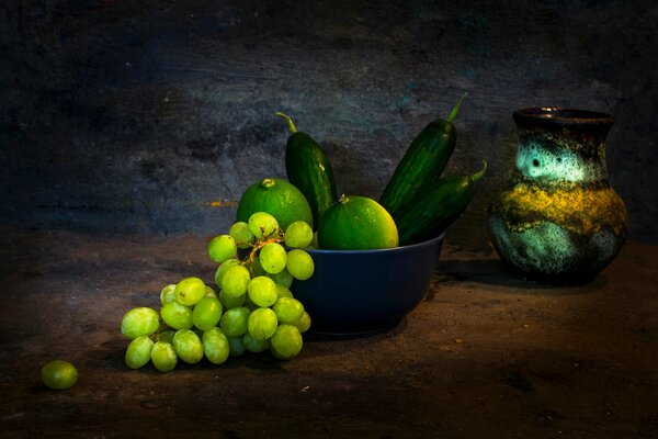 Bunches of grapes with vegetables and a jug