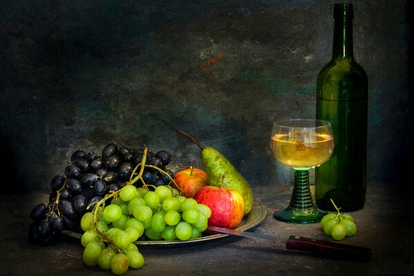 Still life with a bottle of white wine and fruit