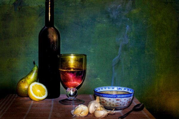 Still life from a bowl of soup and a bottle