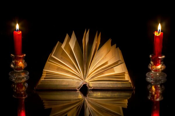 A book on the table with candles