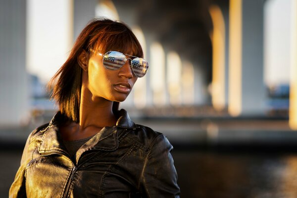 A girl with glasses reflecting the flag of America