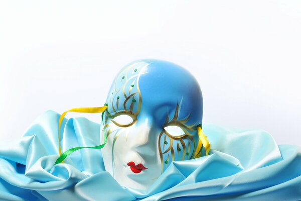 Theatrical mask on blue fabric