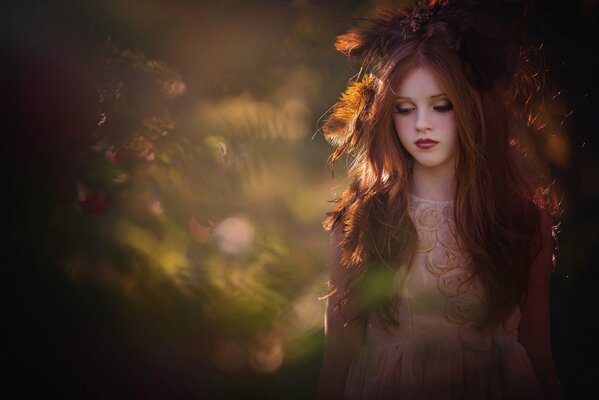 Cute girl with a wreath of flowers on her head