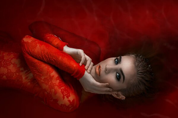 Girl in red in red water