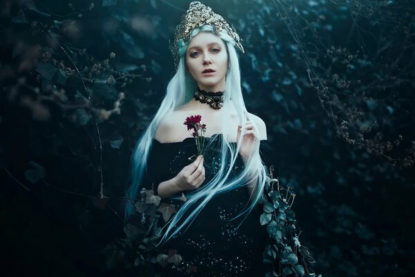 An unusual image of a long-haired blonde with a flower in her hand