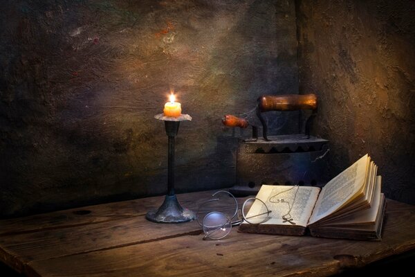 A book on the background of a burning candle