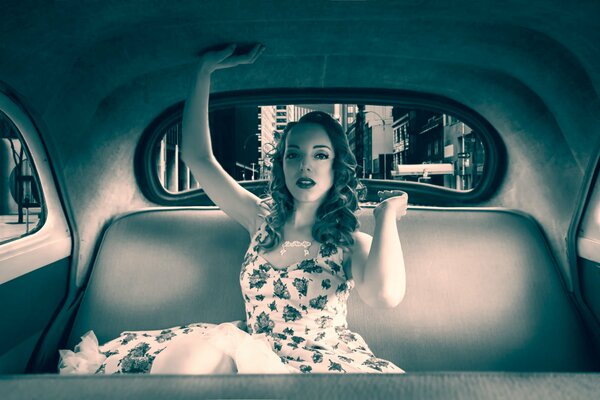 Beautiful girl in a retro car