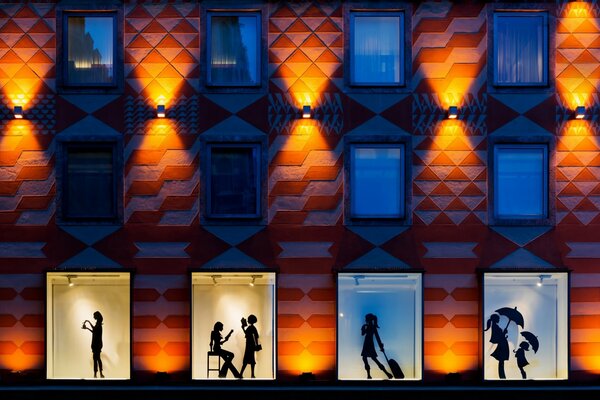 Windows of houses and silhouettes of people in them each has its own style of the city