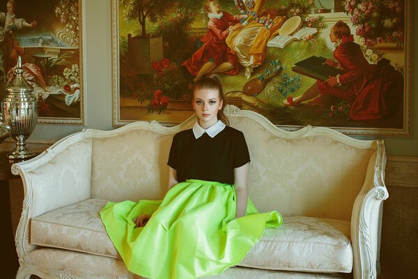 A girl surrounded by antique furniture