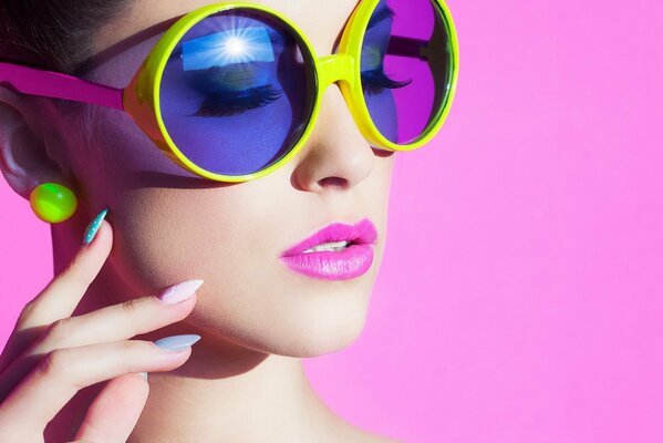 Girl with glasses on pink background