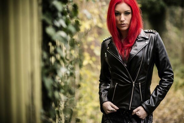 A girl in a leather jacket with red hair