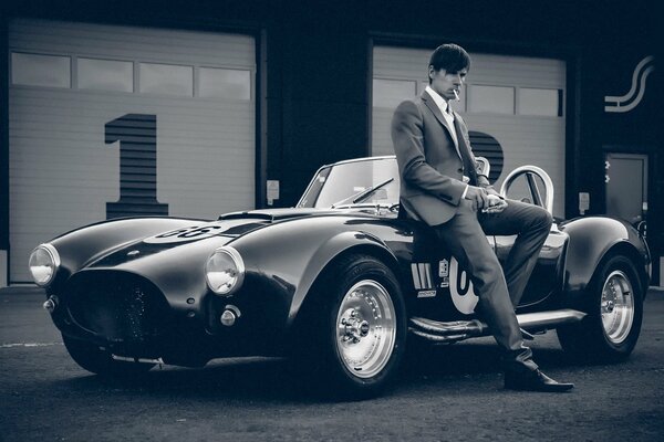 A man sitting on a retro car