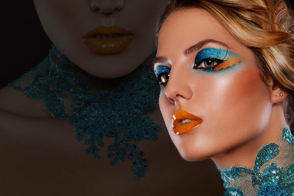 Stylish makeup for the model. Bright blue pearl shadows emphasize the beauty of the eyes