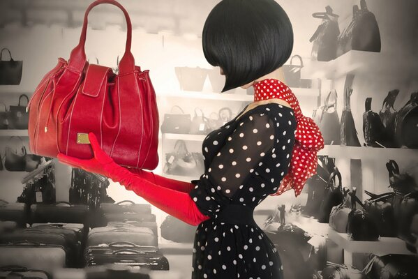 Classic style: black dress with white polka dots, red bag and gloves, square haircut