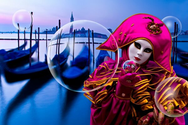 A man in a fancy dress on the background of boats in Venice