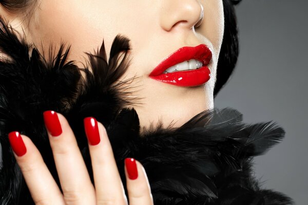 Red lipstick and red nail polish on the girl