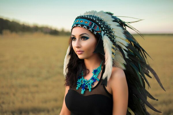 Portrait of a girl in a headdress of an Indian warrior