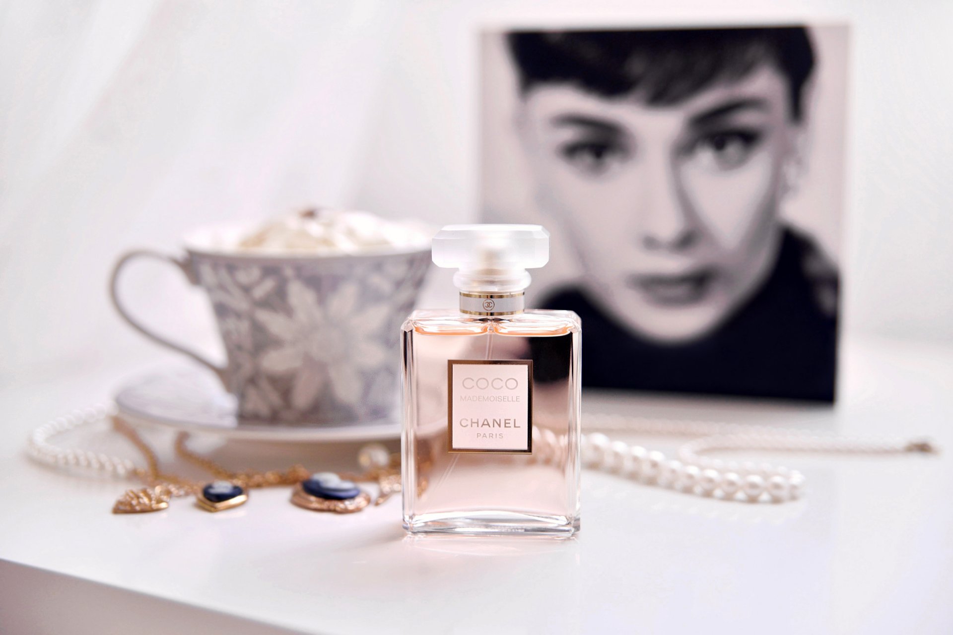 chanel coco mademoiselle profumo tazza piattino perline gioielli pendenti catene ritratto viso ragazza audrey hepburn