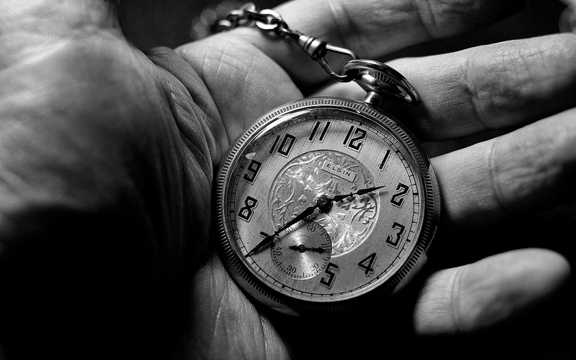 black and white hand clock